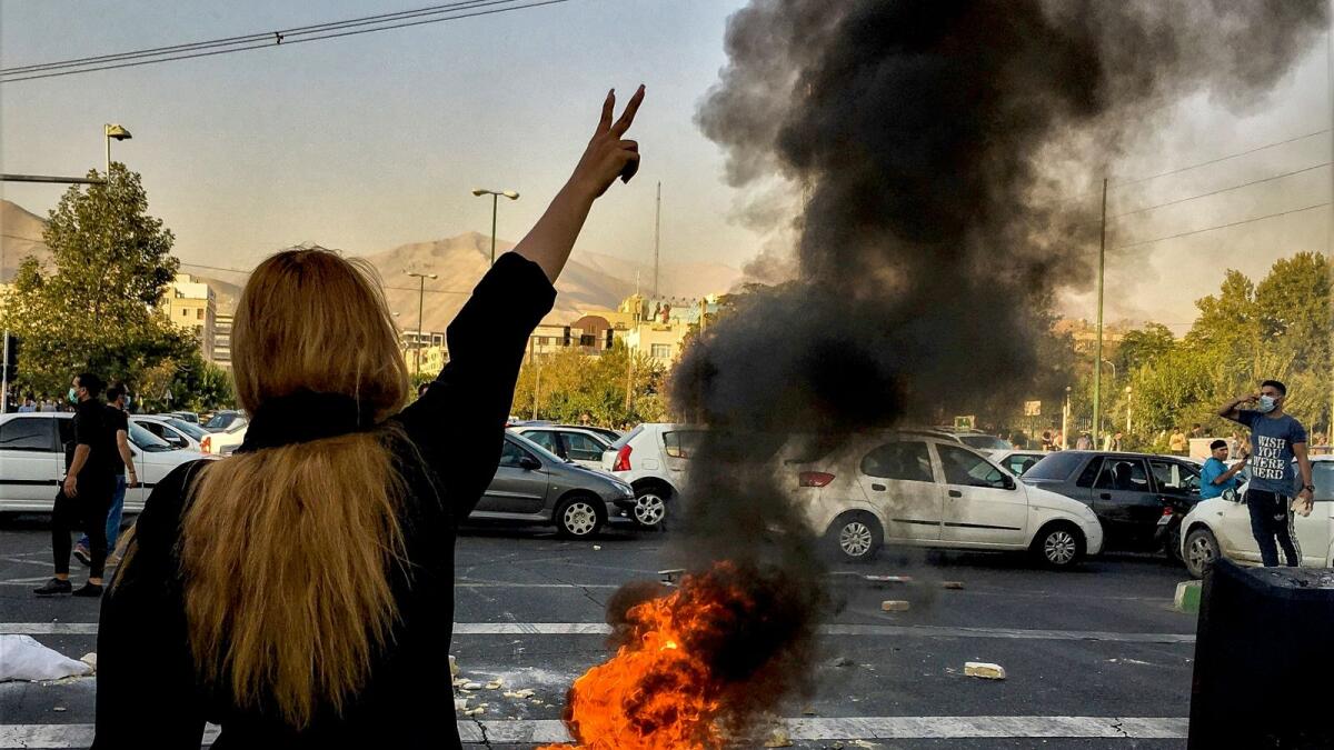 Iranians protest the death of Mahsa Amini in Tehran. — AP