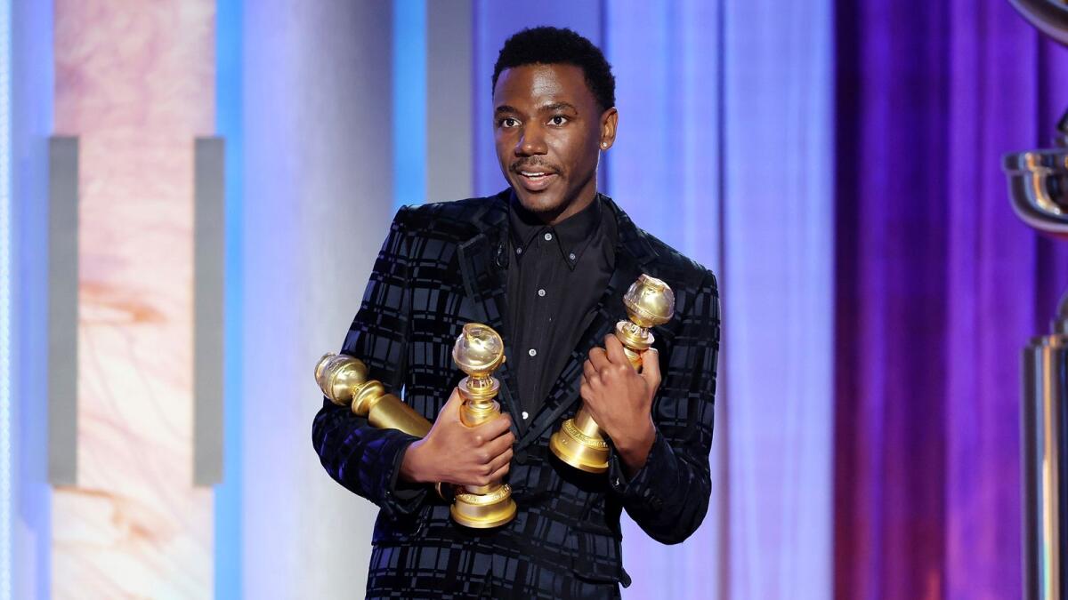 This image released by NBC shows host Jerrod Carmichael holding three Golden Globes during the 80th Annual Golden Globe Awards at the Beverly Hilton Hotel on Tuesday, Jan. 10, 2023, in Beverly Hills, Calif. (Rich Polk/NBC via AP)
