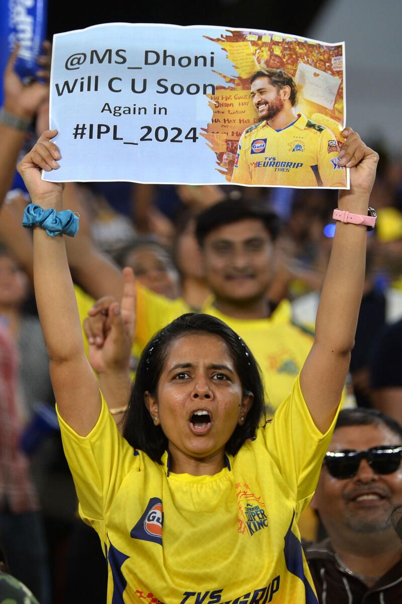 A fans holds up a banner for her hero MS Dhoni. — AFP
