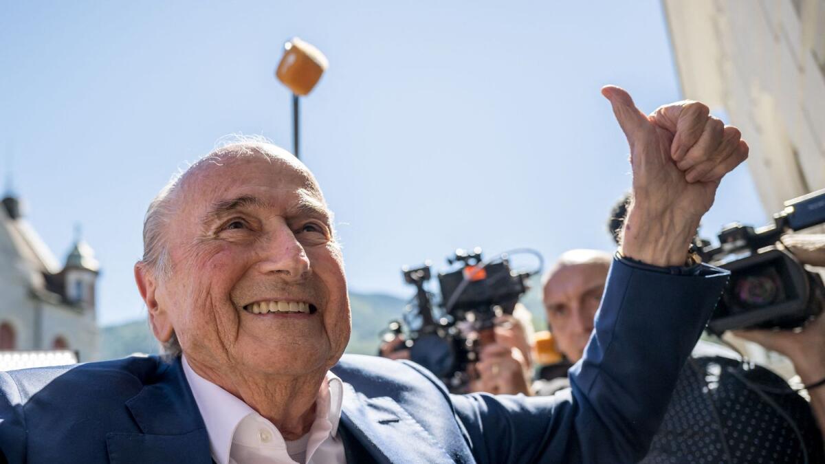 Former Fifa president Sepp Blatter gives a thumb up as he leaves Switzerland's Federal Criminal Court after the verdict of his trial over a suspected fraudulent payment on Friday. — AFP