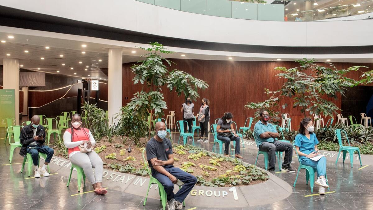 People wait to be vaccindated against COVID-19 at Discovery vaccination site in Sandton, Johannesburg, on December 15, 2021. Photo: AFP