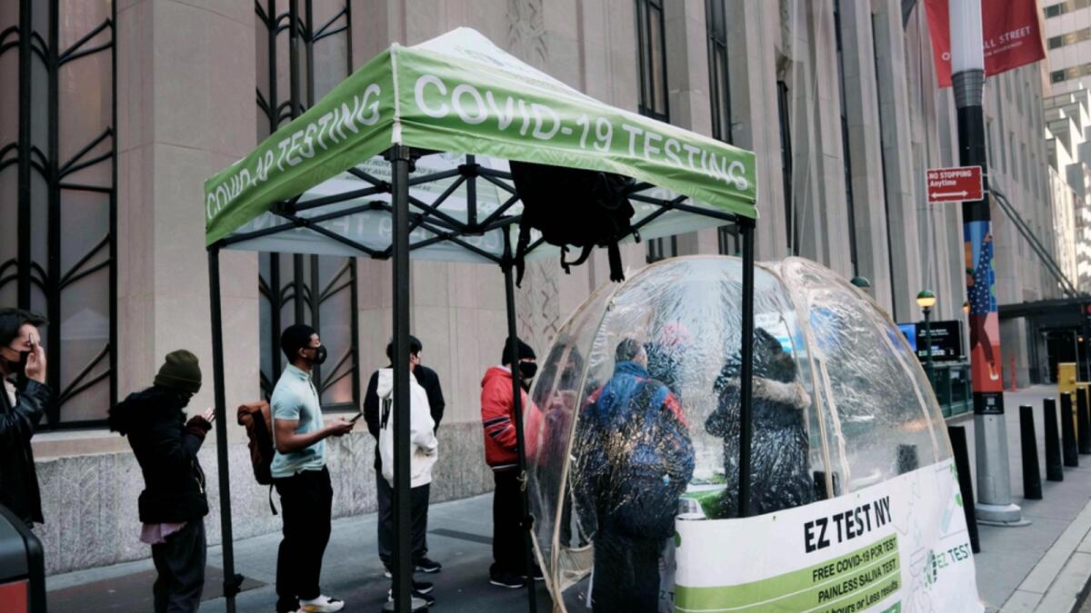 People line-up to take a Covid test at a site in Manhattan. — AFP