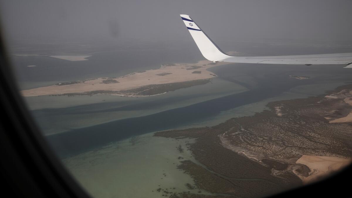 A view through the window of Israeli flag carrier El Al airliner carrying a delegation of Israeli and American officials before the plane lands in Abu Dhabi. Photo: Reuters