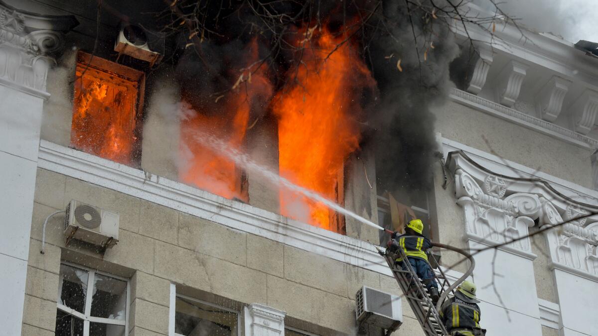 Firefighters work to contain a fire in the complex of buildings housing the Kharkiv regional SBU security service and the regional police, allegedly hit during recent shelling by Russia, in Kharkiv on March 2, 2022. Photo: AFP