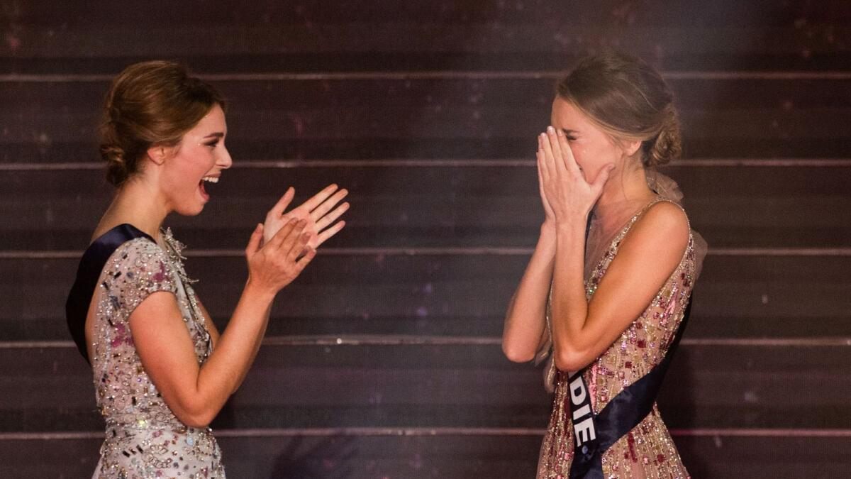 Newly elected Miss France 2021 Miss Normandie Amandine Petit (R) reacts in front of Miss Provence April Benayoum at the end of the Miss France 2021 beauty contest at the Puy-du-Fou, in Les Epesses, western France, on December 20, 2020.