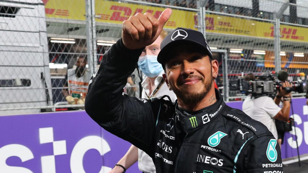 Mercedes' British driver Lewis Hamilton celebrates after taking the pole position. (AFP)