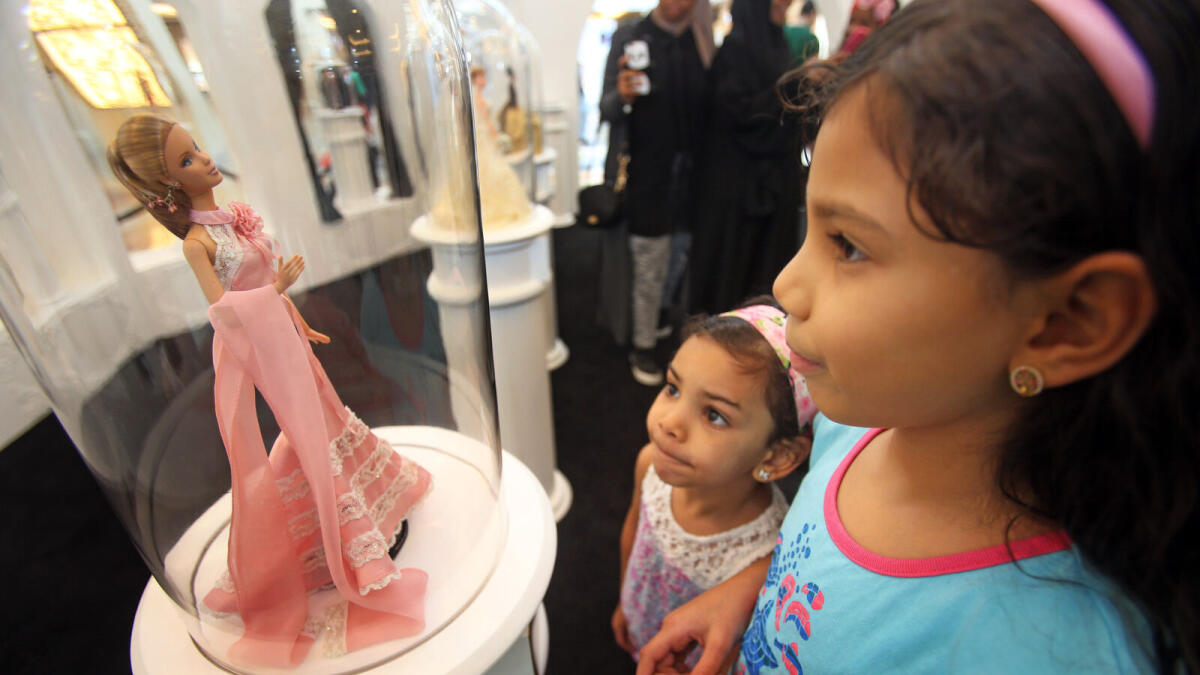 Girls happily look at one of the Barbie Dolls at the exhibit at the Mall of Emirates in Dubai. – Photo by Dhes Handumon/ Khaleej Times