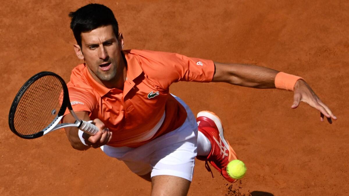 Novak Djokovic plays a return to Aslan Karatsev during their first round match. (AFP)