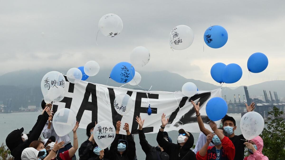 Four families and members of the Save12HKers campaign group fly balloons towards Yantian in mainland China at Crooked Island, Hong Kong, the closest point to Yantian District Detention Centre where 12 Hong Kong people have been held for three months after trying to flee the city to Taiwan in August.
