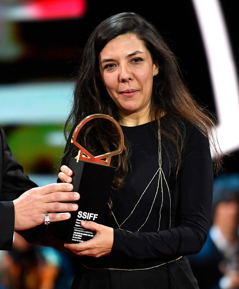 Colombian director Laura Mora receives the Golden Shell award for Los Reyes del Mundo