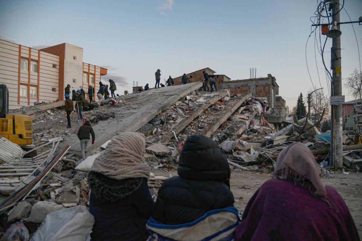 Residents and rescue personnel searching for victims and survivors through the rubble of collapsed buildings in Adiyaman. Photo: AFP