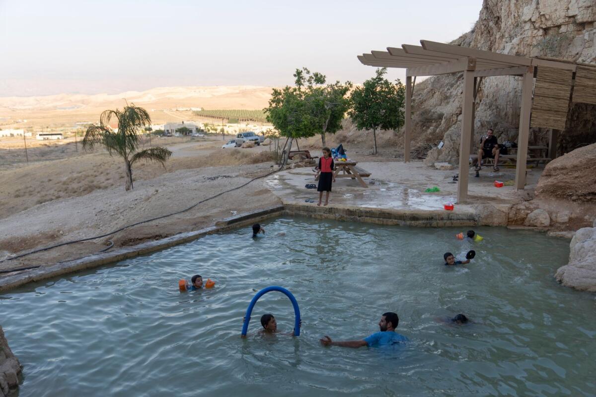 Israeli children swim in a pool at the Jewish settlement of Mevo'ot Yericho, in the Jordan Valley near the Palestinian city of Jericho, on Friday, Aug. 11, 2023. -- AP