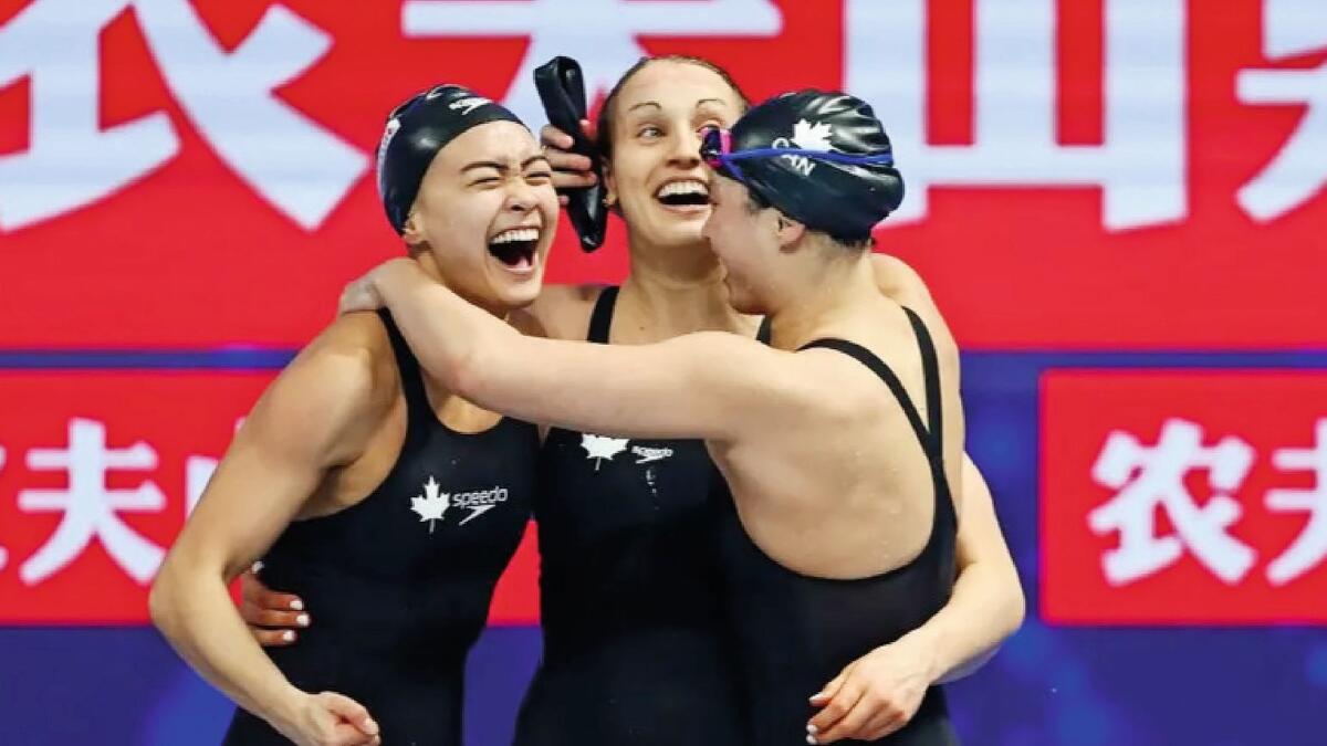 All smiles: The Canadian 4x100m freestyle relay team celebrate after being tiedfor gold with USA. — Supplied photo