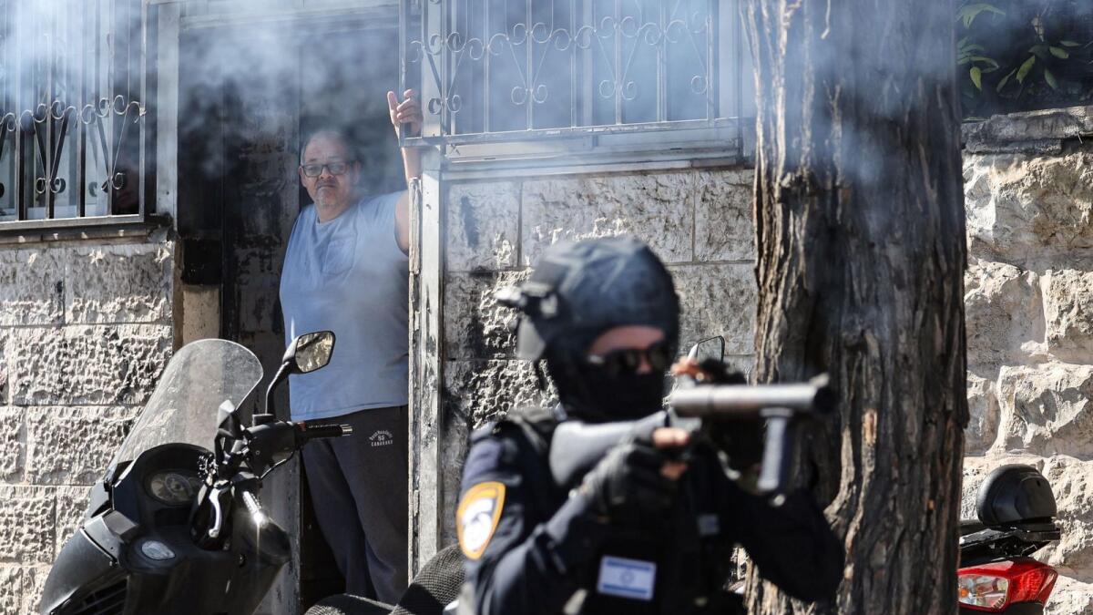 Members of Israeli security forces launch tear gas during clashes with Palestinian protesters in the Wadi Joz neighbourhood in east Jerusalem, on November 24, 2023. AFP
