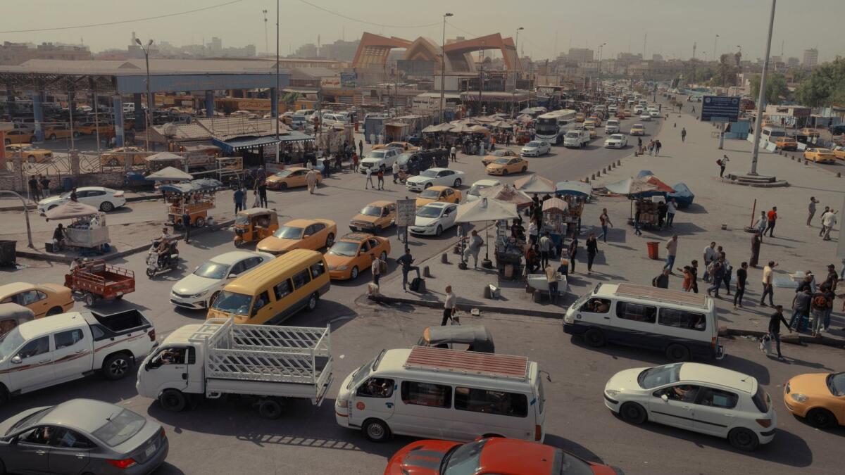 A busy intersection in Baghdad. In a city where summer temperatures have reached up to 125 degrees Fahrenheit, the heat and increased air pollution pose particular hazards for the poor. (Emily Garthwaite/The New York Times)