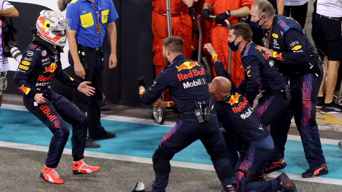 Max Verstappen celebrates with members of his team after winning the thrilling race. (AFP)