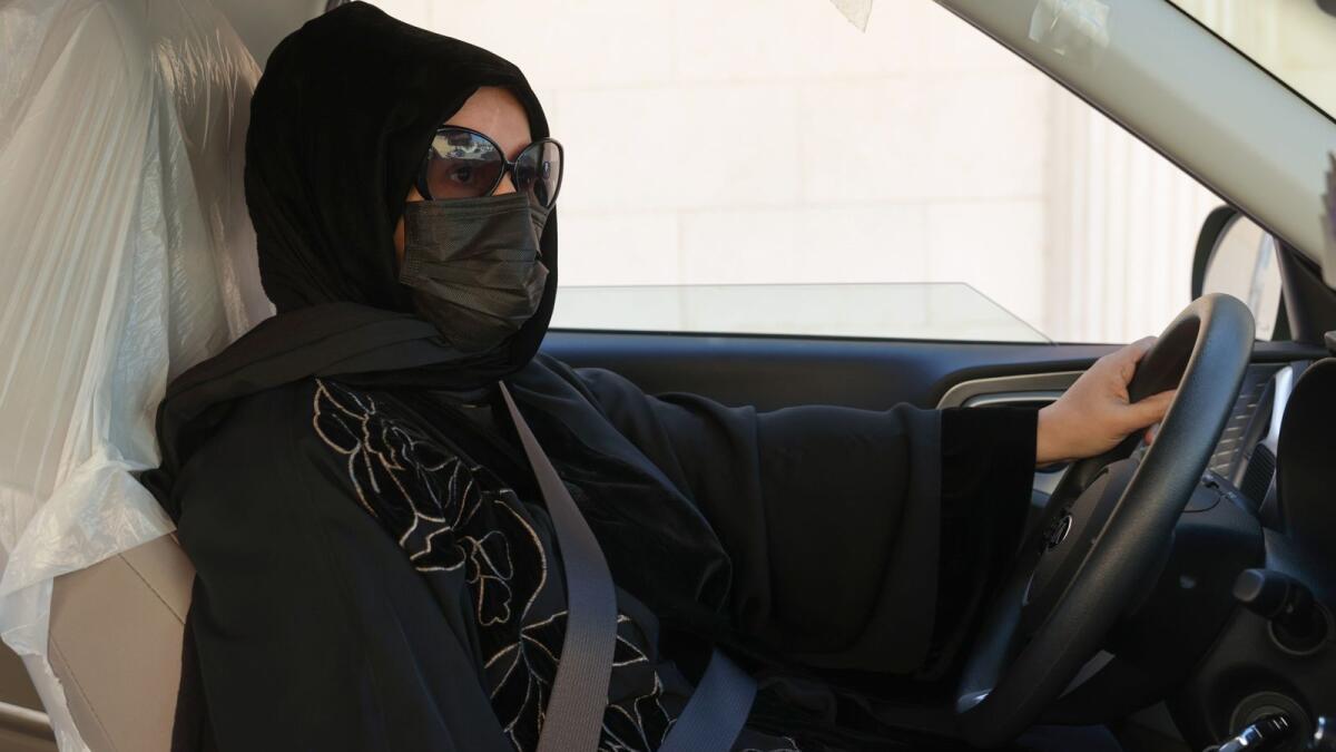 Saudi taxi driver Fahda Fahd sits in her car in the capital Riyadh, on February 8, 2022 Photo: AFP
