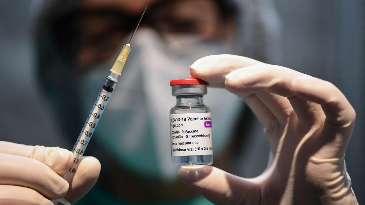 A medical worker holds a syringe and a vial of the AstraZeneca/Oxford vaccine during a vaccination campaign at the National Museum of Science and Technology Leonardo Da Vinci. — AFP file