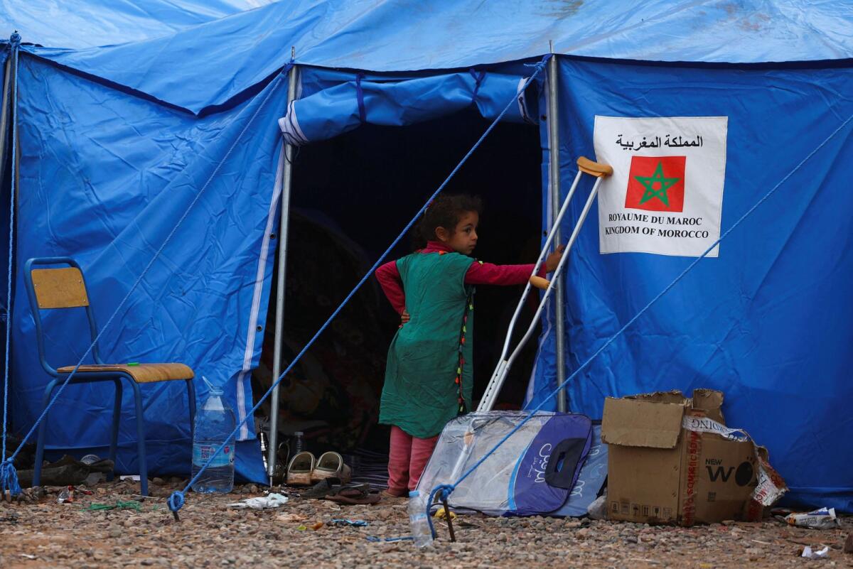 A girl stands by a tent in the aftermath of a deadly earthquake in Talat N'Yaaqoub in Morocco on Tuesday. — reuters