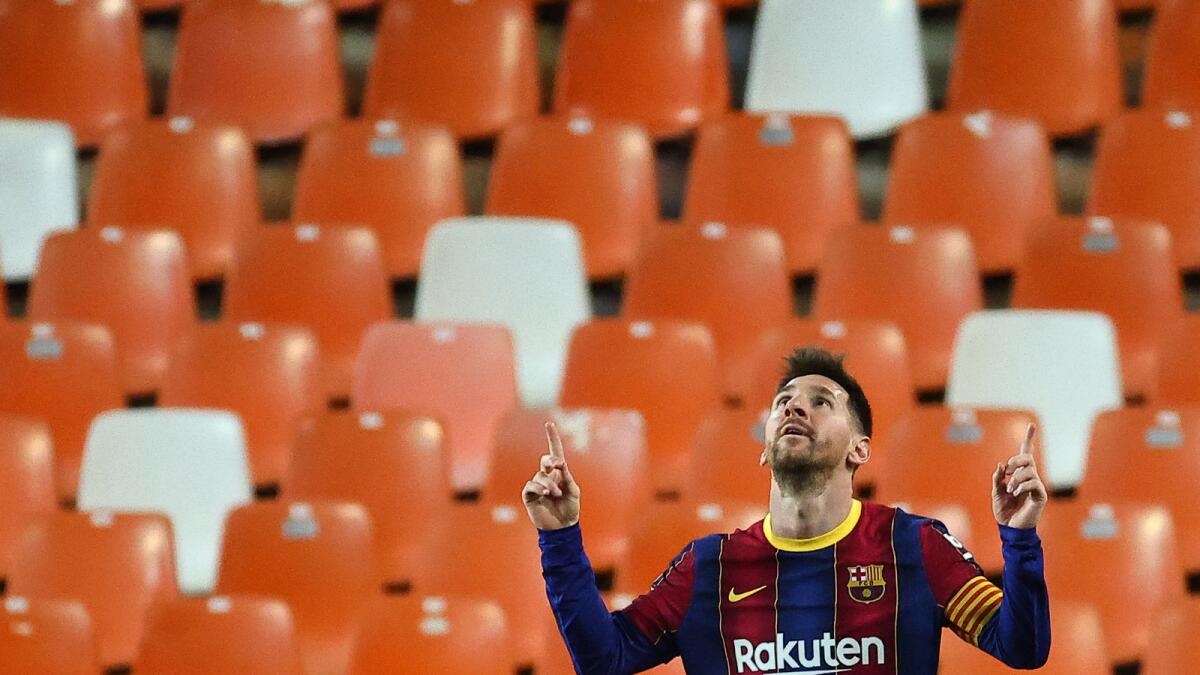 Barcelona's Lionel Messi celebrates scoring his second goal during the La Liga match against Valencia on Sunday. (AFP)