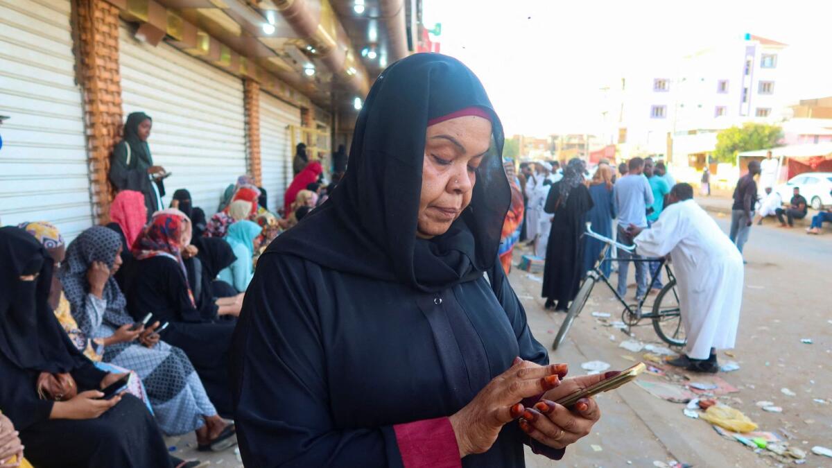 Residents and displaced people try to access the internet via Starlink in the city of Omdurman, Sudan, on March 9, 2024. — Reuters