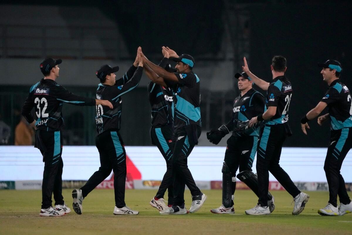 New Zealand players celebrate after the dismissal of Pakistan's Shadab Khan. — AP