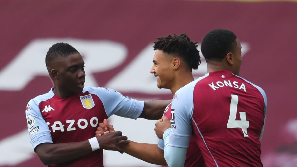 Aston Villa's English striker Ollie Watkins (centre) celebrates with teammates after scoring a goal against Arsenal during the English Premier League match. — AFP