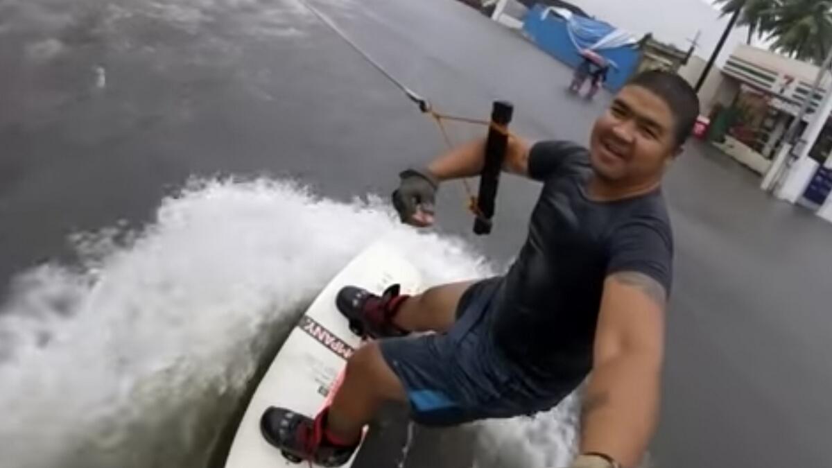 Video: Man goes surfing on flooded street