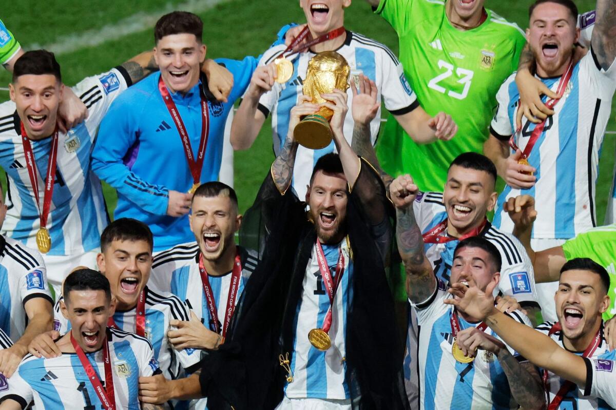 Messi lifts the World Cup trophy during the Qatar 2022 World Cup trophy ceremony. — AFP