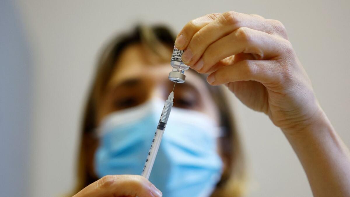 A medical worker prepares a dose of the 'Cominarty' Pfizer-Bivalent Covid-19 vaccine at a vaccination centre in Nice as a new surge in the disease starts in France. — Reuters