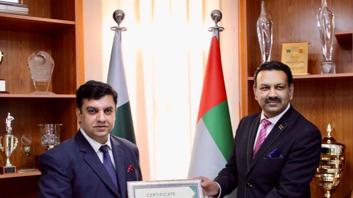 Sohail Sheikh, country manager of Serene Air in the UAE, presenting a certificate of appreciaton to Pakistan’s Consul General in Dubai and Northern Emirates Ahmed Amjad Ali for his support in repatriation of stranded Pakistanis during the lockdown period last year. — Supplied photo