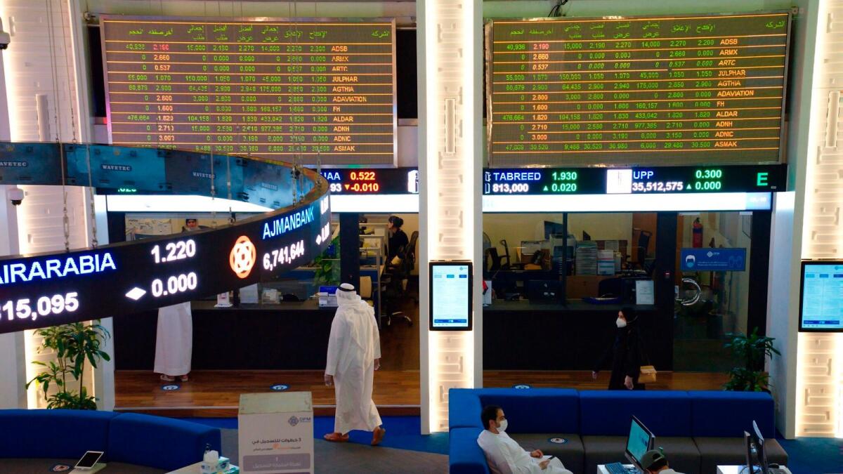 Emiratis work on the floor of the Dubai Financial Market in Dubai. Last year was phenomenal for Dubai equity and capital markets with IPO coming from the emirate’s top-notch companies including Salik Company, Dubai Electricity and Water Authority and Tecom Group. — AP file photo