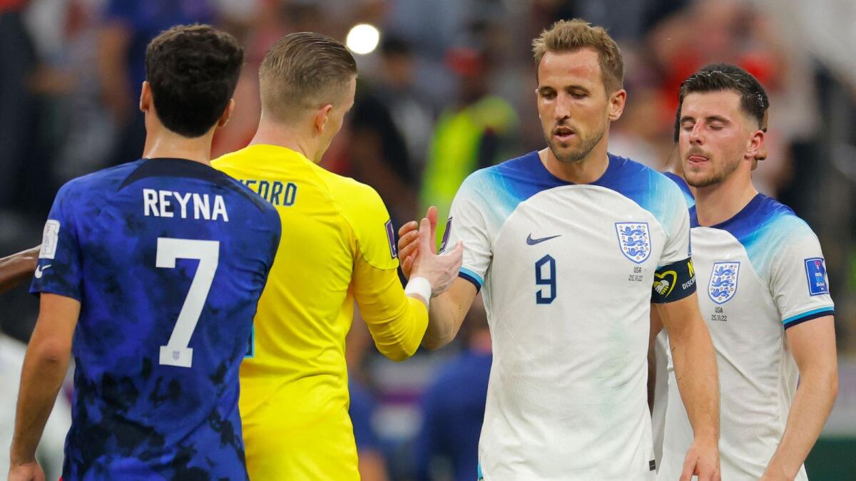 England's forward Harry Kane (2nd R) greets goalkeeper Jordan Pickford (2nd L) at the end of the Qatar 2022 World Cup Group B football match between England and USA . — AFP