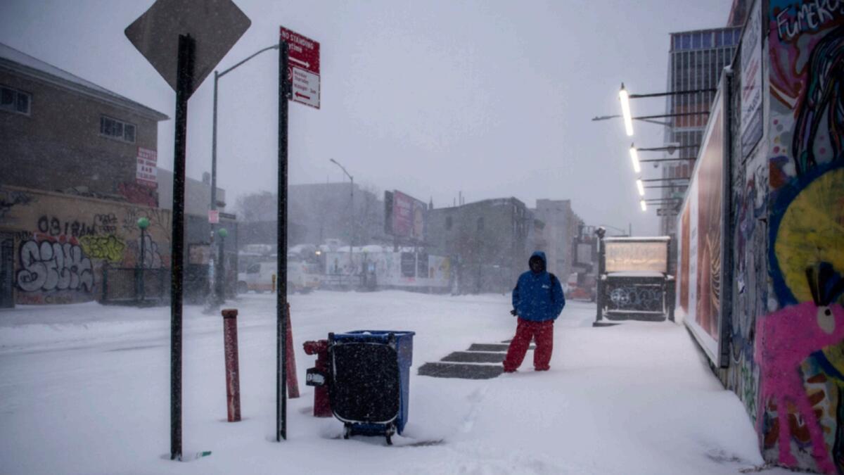 Snow covers the street in the Bushwick section of the Brooklyn borough of New York. — AP