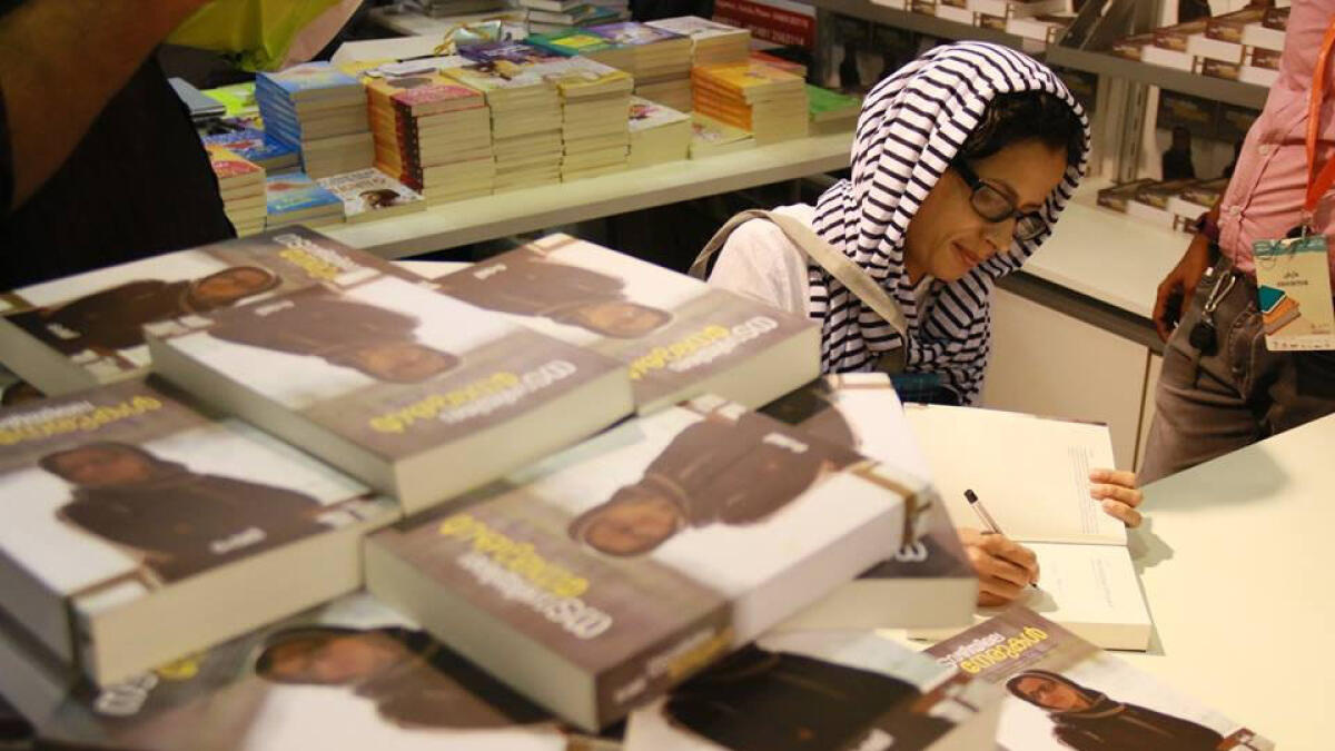Shemi signing her book.