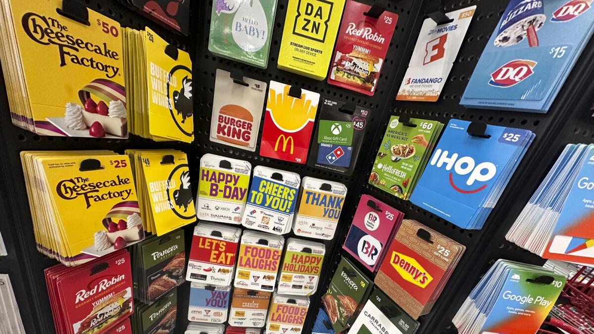 Gift cards are displayed at a Target store in New York. Americans are expected to spend nearly $30 billion on gift cards this holiday season, according to the National Retail Federation. — AP