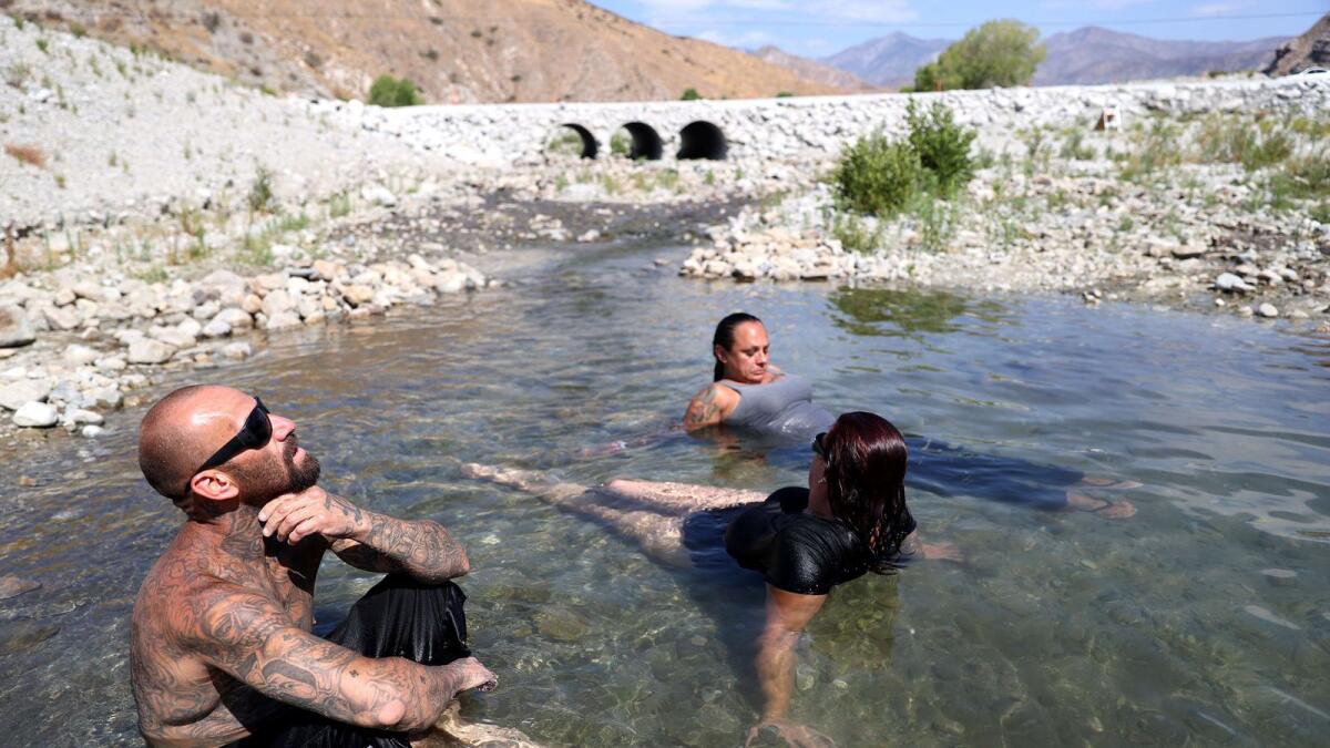 Southern California residents cool off in the Whitewater River on Saturday in Whitewater, California. Dangerously hot conditions are expected to hit the Coachella Valley this weekend with possible highs of 115 to 120 degrees, according to the National Weather Service.