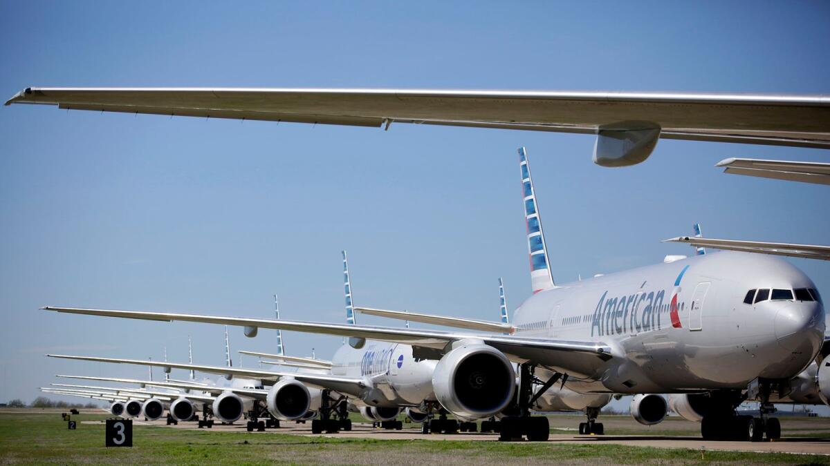 American Airlines 777's airplanes are  parked at Tulsa International Airport. American Airlines has 44 out of service airplanes parked at the airport due to a reduced flight schedule because of the Covid-19 pandemic. — File photo