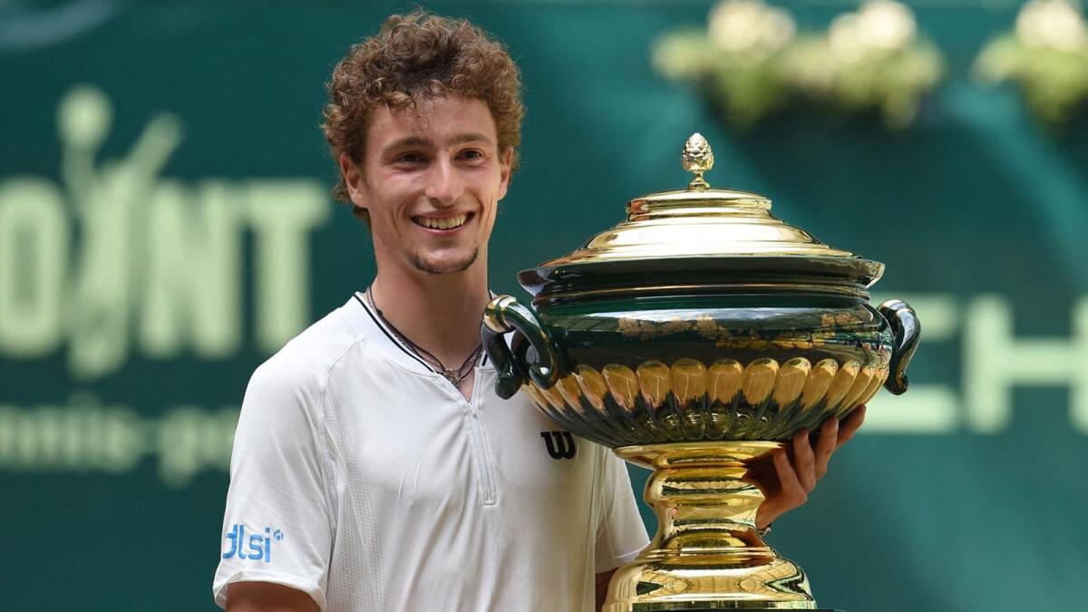 France's Ugo Humbert celebrates with the trophy after winning the ATP 500 Halle Open tennis tournament in Halle, western Germany. — AFP