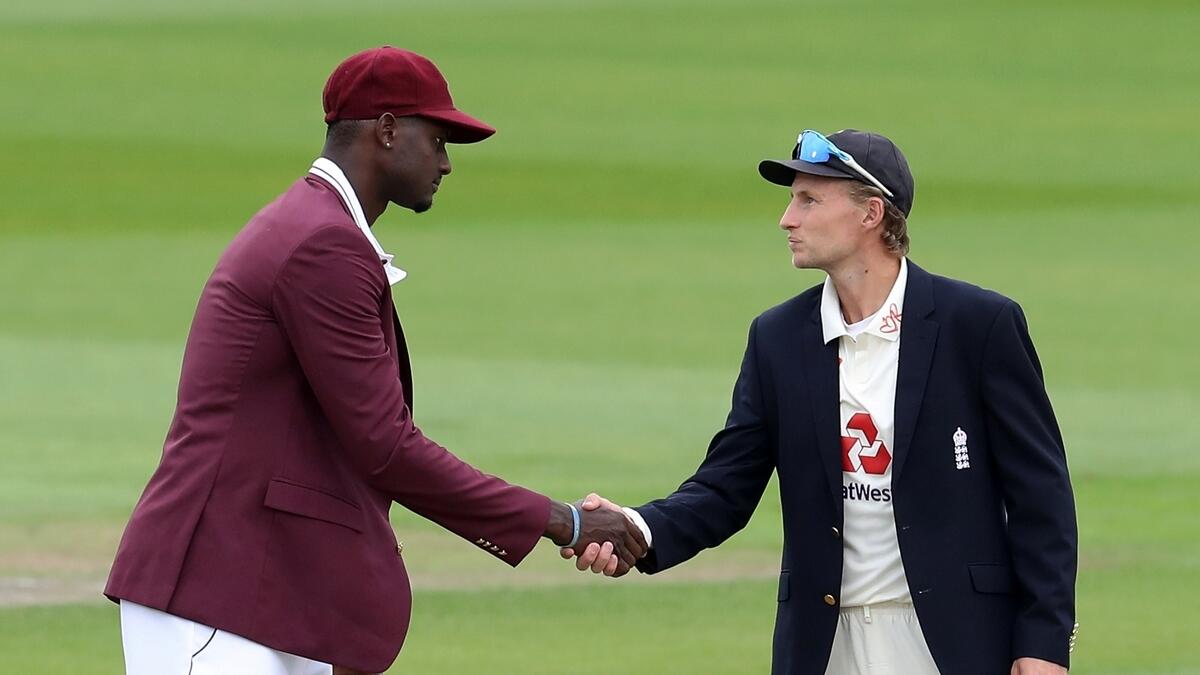 England's Joe Root and West Indies' Jason Holder shake hands after the toss before the start of play