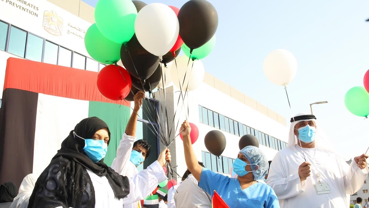 When the team flew the hospital, healthcare workers stepped out for a moment and waved miniature UAE flags in the air.  Photo by Juidin Bernarrd