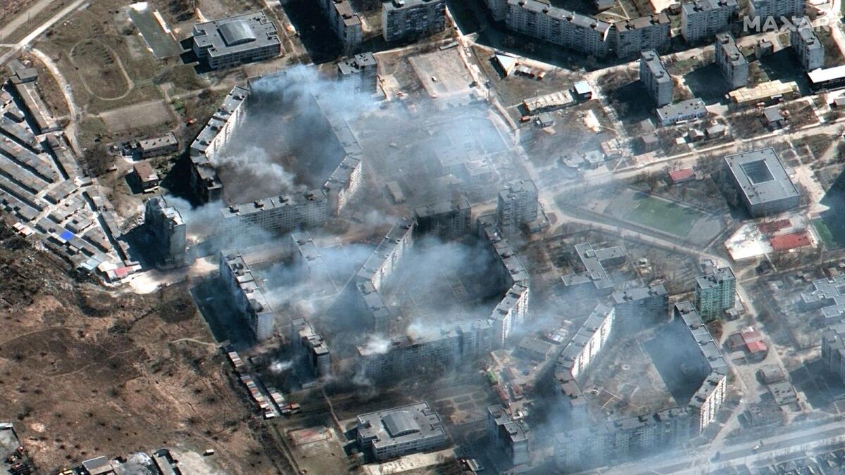 This Maxar satellite image taken on March 19, 2022 and released on March 21, 2022 shows burning apartment buildings, 'likely shelled by artillery' according to Maxar, and burning buildings in northeastern Mariupol, Ukraine. Photo: AFP
