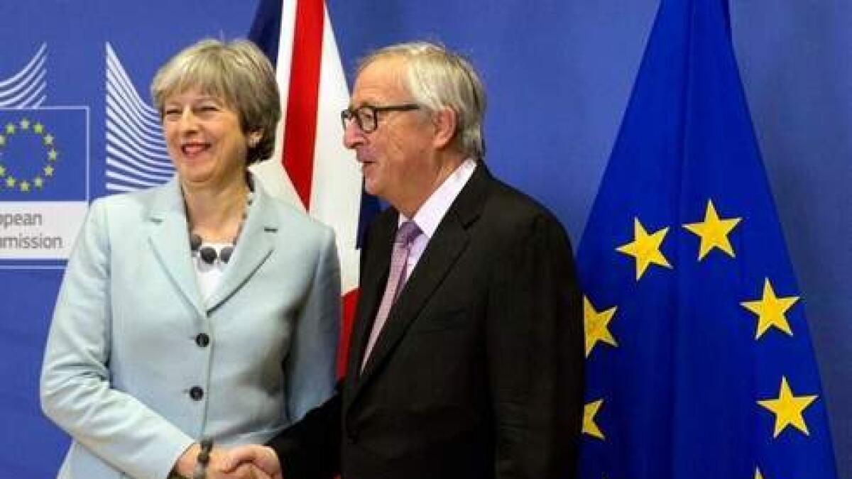 British Prime Minister Theresa May with European Commission President Jean-Claude Juncker.-AP File photo
