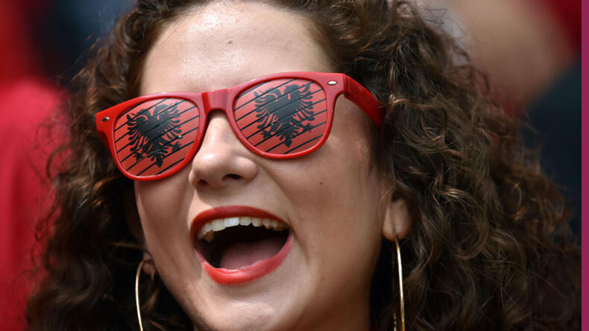 An Albania supporter cheers for her team. (AFP)
