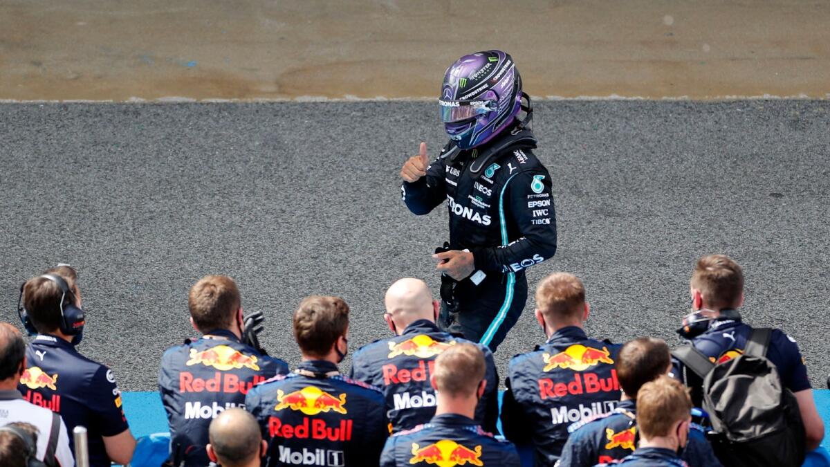 Mercedes' Lewis Hamilton celebrates after winning the race. — Reuters