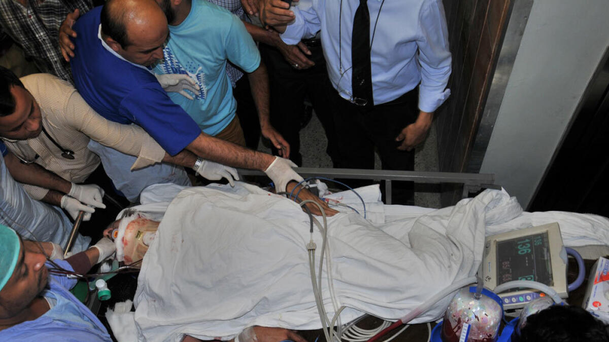In this handout photograph received from MQM, paramedics move critically injured Rashid Godil through a hospital.