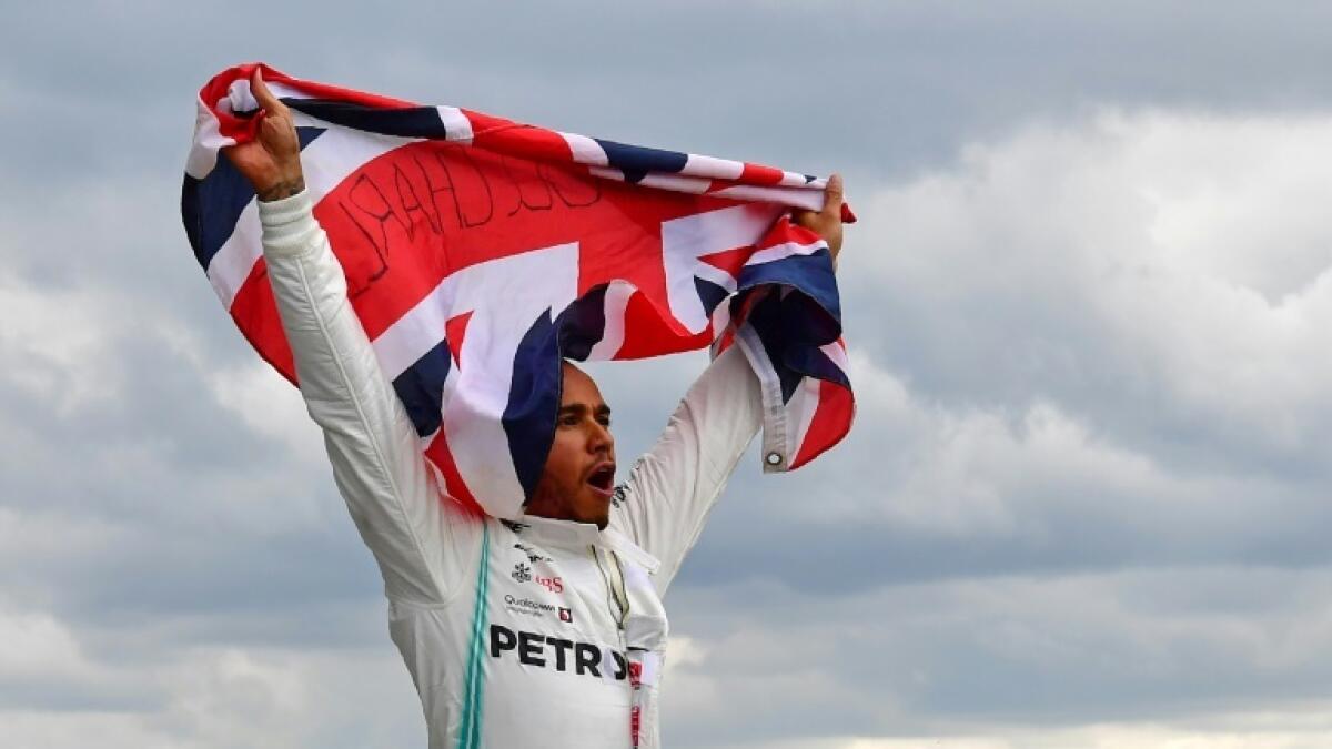 Lewis Hamilton celebrates after winning last season's British Grand Prix. - AFP file