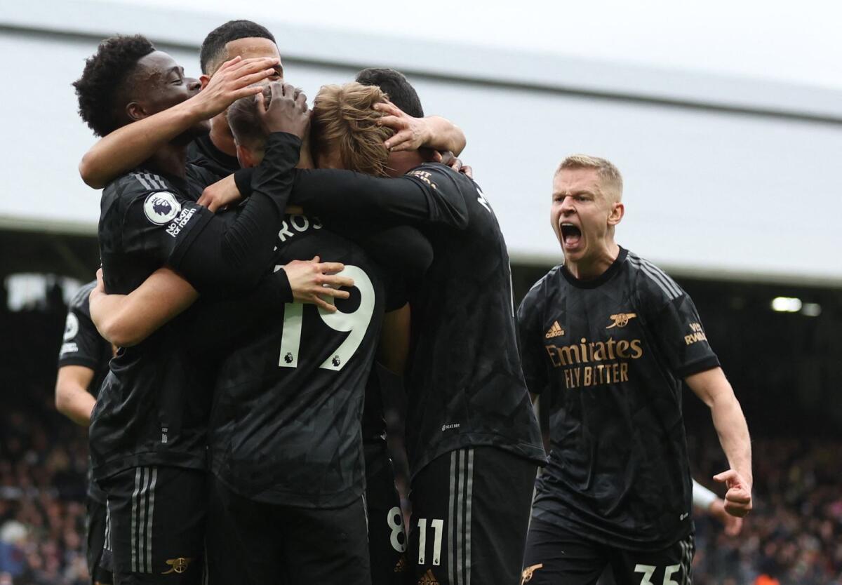 Arsenal's Martin Odegaard celebrates scoring their third goal with teammates. — Reuters