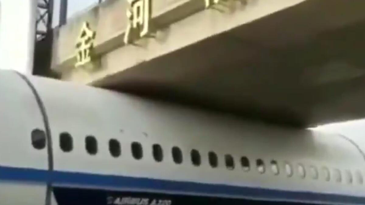 Plane, Plane stuck under bridge, china, viral video, off beat 