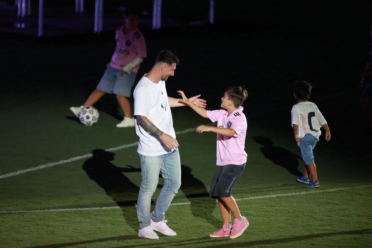 Lionel Messi interacts with his son during 'The Unveil'. — AFP
